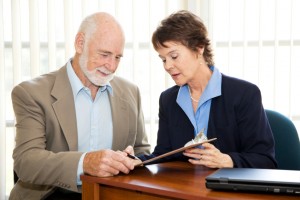 Take This Important Tax Step Now | Paul McNulty, CFP® | Boston Metro Advisor Senior man signing a contract in his attorney's office.