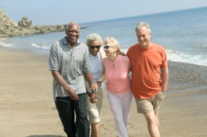 Couples Walking Together On Beach